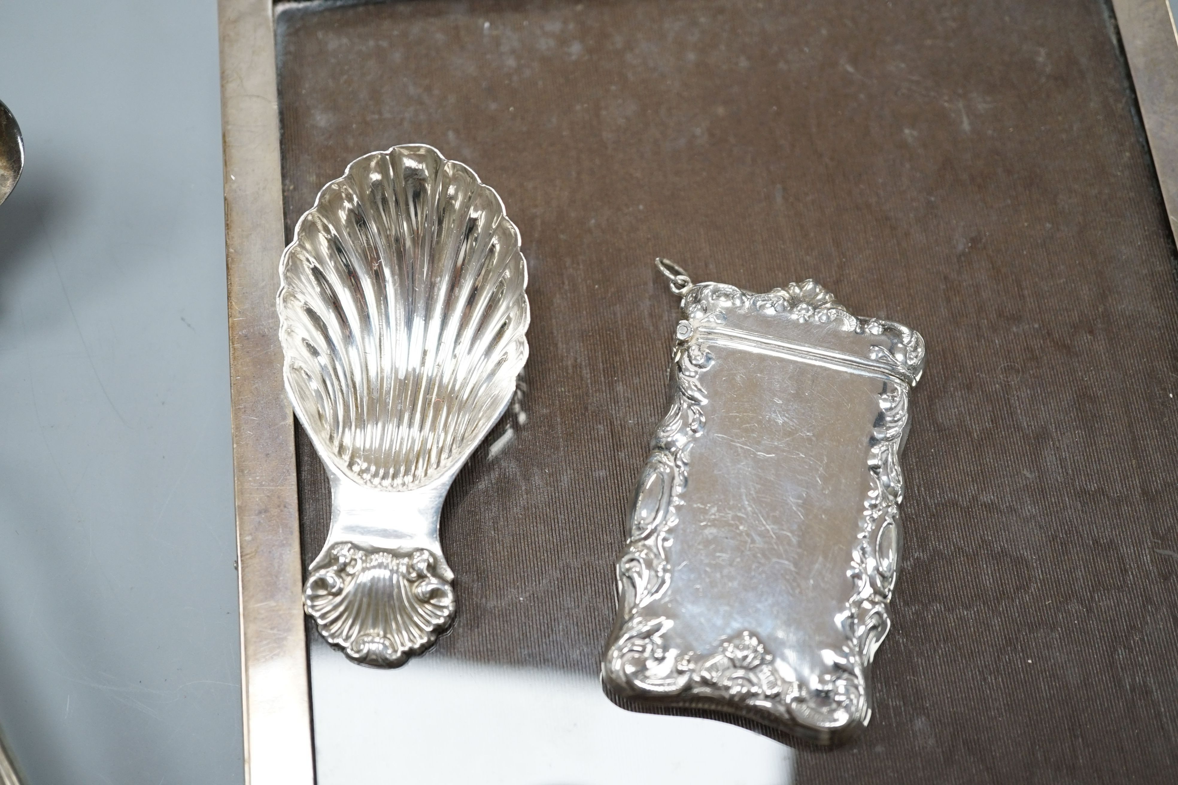 A Georgian style silver toddy ladle, London 1976, a silver mounted rectangular photograph frame, a caddy spoon, and a vesta case stamped Sterling